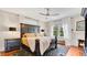 Cozy bedroom with a dark wood bed frame, plush bedding, and a decorative brick fireplace, and modern ceiling fan at 900 S Palmetto Ave, Sanford, FL 32771