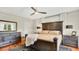 Bedroom with a dark wood bed frame, dresser, and nightstands with lamp lighting. Hardwood floors with geometric rug at 900 S Palmetto Ave, Sanford, FL 32771