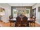 Elegant dining room with dark wood table, leather chairs, modern chandelier, and decorative wallpaper at 900 S Palmetto Ave, Sanford, FL 32771