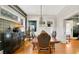 Beautiful dining room featuring wood floors, stylish furniture, and ample natural light from large windows at 900 S Palmetto Ave, Sanford, FL 32771
