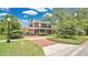 Inviting home featuring a brick driveway, covered parking, and a charming front porch at 900 S Palmetto Ave, Sanford, FL 32771
