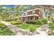 A picturesque home with a large tree, front porch, and well-maintained landscaping at 900 S Palmetto Ave, Sanford, FL 32771