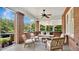 Relaxing screened-in porch with comfortable seating, ceiling fan, and charming decor at 900 S Palmetto Ave, Sanford, FL 32771