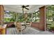 Cozy screened porch featuring a round table, chairs, and an inviting atmosphere at 900 S Palmetto Ave, Sanford, FL 32771