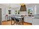 Bright kitchen with white cabinets, stainless steel appliances, an island with seating, and hardwood floors at 900 S Palmetto Ave, Sanford, FL 32771