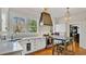 Stylish kitchen featuring white cabinetry, marble countertops, stainless steel appliances, and an eat-in island at 900 S Palmetto Ave, Sanford, FL 32771