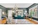 Well-decorated living room featuring a comfortable sofa, stylish lighting, and hardwood floors at 900 S Palmetto Ave, Sanford, FL 32771