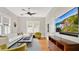 Cozy living room with hardwood floors, a large window, a TV, and comfortable seating arrangements at 900 S Palmetto Ave, Sanford, FL 32771
