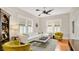 Bright living room featuring hardwood floors, large windows, and stylish furniture creating an inviting atmosphere at 900 S Palmetto Ave, Sanford, FL 32771