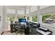 Bright home office with modern desk, office chair, and large windows offering lots of natural light at 900 S Palmetto Ave, Sanford, FL 32771