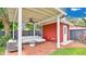 Covered patio area featuring comfortable seating and an outbuilding with a door at 900 S Palmetto Ave, Sanford, FL 32771