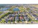 Aerial view of community featuring a lake, fountain, playground and pool; property highlighted with red pin at 9038 Sunshine Ridge Loop, Kissimmee, FL 34747