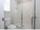 Bright bathroom showcasing a clean, glass-enclosed shower and toilet at 9038 Sunshine Ridge Loop, Kissimmee, FL 34747
