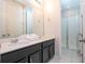 Modern bathroom with double sink vanity, ample counter space, and glass-enclosed shower at 9038 Sunshine Ridge Loop, Kissimmee, FL 34747