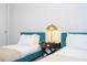 Cozy bedroom with two twin beds, stylish wallpaper, and gold table lamp at 9038 Sunshine Ridge Loop, Kissimmee, FL 34747