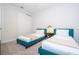 Cozy bedroom with two twin beds, stylish wallpaper, and closet space at 9038 Sunshine Ridge Loop, Kissimmee, FL 34747
