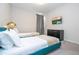 Bright bedroom featuring two twin beds, a TV, and a dark dresser at 9038 Sunshine Ridge Loop, Kissimmee, FL 34747