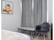 Cozy bedroom corner featuring modern decor with a gray upholstered bench and a black chair at 9038 Sunshine Ridge Loop, Kissimmee, FL 34747