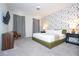 Bright main bedroom features a king bed, decorative wallpaper, and two large windows with light-blocking curtains at 9038 Sunshine Ridge Loop, Kissimmee, FL 34747