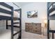 A bedroom features two bunk beds, a mounted TV and a dresser with a decorative lamp at 9038 Sunshine Ridge Loop, Kissimmee, FL 34747