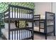 Bedroom featuring two sets of bunk beds with neutral bedding, leafy accent wall, and plush carpeting at 9038 Sunshine Ridge Loop, Kissimmee, FL 34747