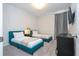 Cozy bedroom with two twin beds, stylish wallpaper, and convenient side table at 9038 Sunshine Ridge Loop, Kissimmee, FL 34747