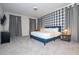 Large bedroom featuring a blue bed frame, plaid accent wall, and bright window at 9038 Sunshine Ridge Loop, Kissimmee, FL 34747
