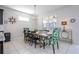 Dining room with decorative lighting, stylish furniture and an adjacent view of the kitchen at 9038 Sunshine Ridge Loop, Kissimmee, FL 34747