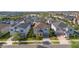 Well-maintained two-story home with a paved driveway leading to a two-car garage, surrounded by lush landscaping at 9038 Sunshine Ridge Loop, Kissimmee, FL 34747