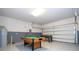 Spacious game room featuring a foosball table and pool table for endless entertainment at 9038 Sunshine Ridge Loop, Kissimmee, FL 34747