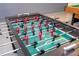 Close-up of a modern foosball table with red and black players on a green field at 9038 Sunshine Ridge Loop, Kissimmee, FL 34747