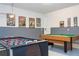 Entertainment room with pool table, foosball table, and colorful wall decor at 9038 Sunshine Ridge Loop, Kissimmee, FL 34747
