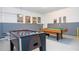 Foosball table and pool table in entertainment room with fun posters at 9038 Sunshine Ridge Loop, Kissimmee, FL 34747