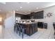 Spacious kitchen features stainless steel appliances, granite countertops, island with seating and stylish, dark cabinets at 9038 Sunshine Ridge Loop, Kissimmee, FL 34747