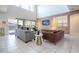 Spacious living room with stylish furniture, tiled floors and a large sliding glass door overlooking a pool at 9038 Sunshine Ridge Loop, Kissimmee, FL 34747