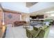 Open-concept living area showcasing a brick accent wall, modern furnishings, and a seamless flow to the kitchen and dining space at 9038 Sunshine Ridge Loop, Kissimmee, FL 34747