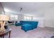 Upstairs living room with large blue couch, table with chairs and a view of the neighborhood at 9038 Sunshine Ridge Loop, Kissimmee, FL 34747