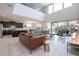 Bright, open-concept living room with modern furnishings, tile floors, and large windows with a view to the patio and pool area at 9038 Sunshine Ridge Loop, Kissimmee, FL 34747