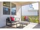 Enclosed patio provides a cozy area with outdoor seating, a coffee table and bright decor at 9038 Sunshine Ridge Loop, Kissimmee, FL 34747