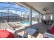 Inviting screened-in pool area with a hot tub, lounge chairs, patio seating, and well-maintained landscaping at 9038 Sunshine Ridge Loop, Kissimmee, FL 34747