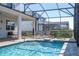 Backyard pool and patio area showing the sun loungers, and enclosed with screening at 9038 Sunshine Ridge Loop, Kissimmee, FL 34747