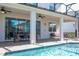 Outdoor patio with a view of the pool, dining table under the patio and covered area at 9038 Sunshine Ridge Loop, Kissimmee, FL 34747