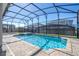 Screened-in pool with a spa and brick-paver patio, ideal for relaxation and enjoying sunny days at 9038 Sunshine Ridge Loop, Kissimmee, FL 34747