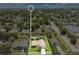 Aerial view of a charming single-Gathering home with a lush green lawn and mature trees at 922 Hatteras Ave, Minneola, FL 34715