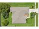 Birds eye view of a home with neutral toned roof, green yard, and nearby street at 922 Hatteras Ave, Minneola, FL 34715