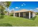 Well-maintained backyard with a screened patio, perfect for entertaining and outdoor relaxation at 922 Hatteras Ave, Minneola, FL 34715