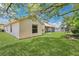 View of a well maintained home's exterior with a screened-in lanai and spacious yard at 922 Hatteras Ave, Minneola, FL 34715