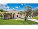 Charming single-story home with manicured lawn, mature tree, and inviting front entrance at 922 Hatteras Ave, Minneola, FL 34715