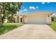 Charming single-story home with a well-manicured lawn and an attached two-car garage at 922 Hatteras Ave, Minneola, FL 34715