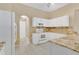 Well-lit kitchen with tile floors, granite counters, and stainless steel appliances at 922 Hatteras Ave, Minneola, FL 34715